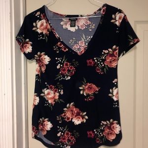 Woman blue casual t-shirt with floral print.